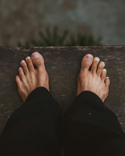 Close-up shot of a person's feet on a mat, showing focus and stability.